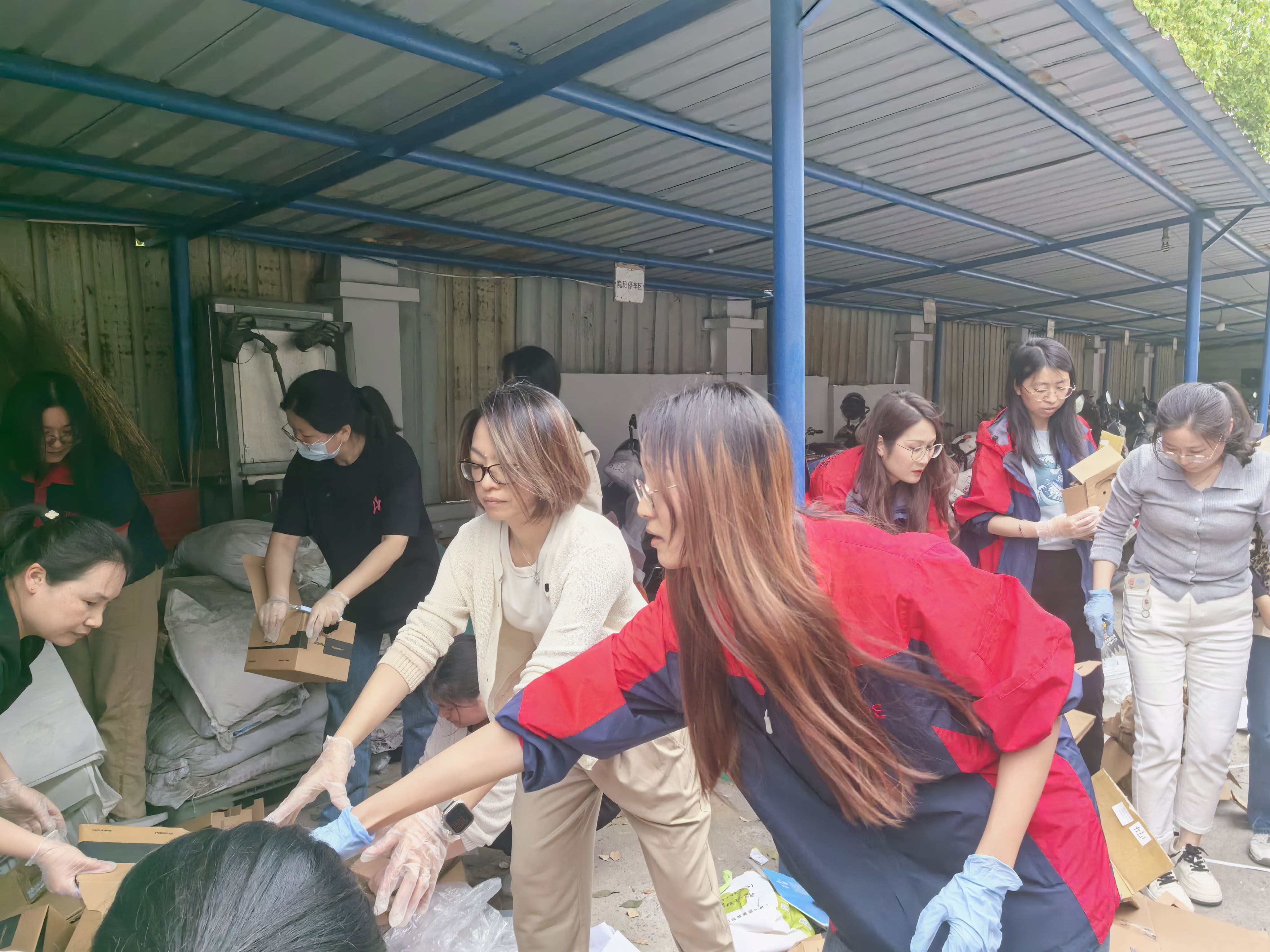 JPE Kunshan employees sorting cardboard and recyclables during the Recycling Day activity.